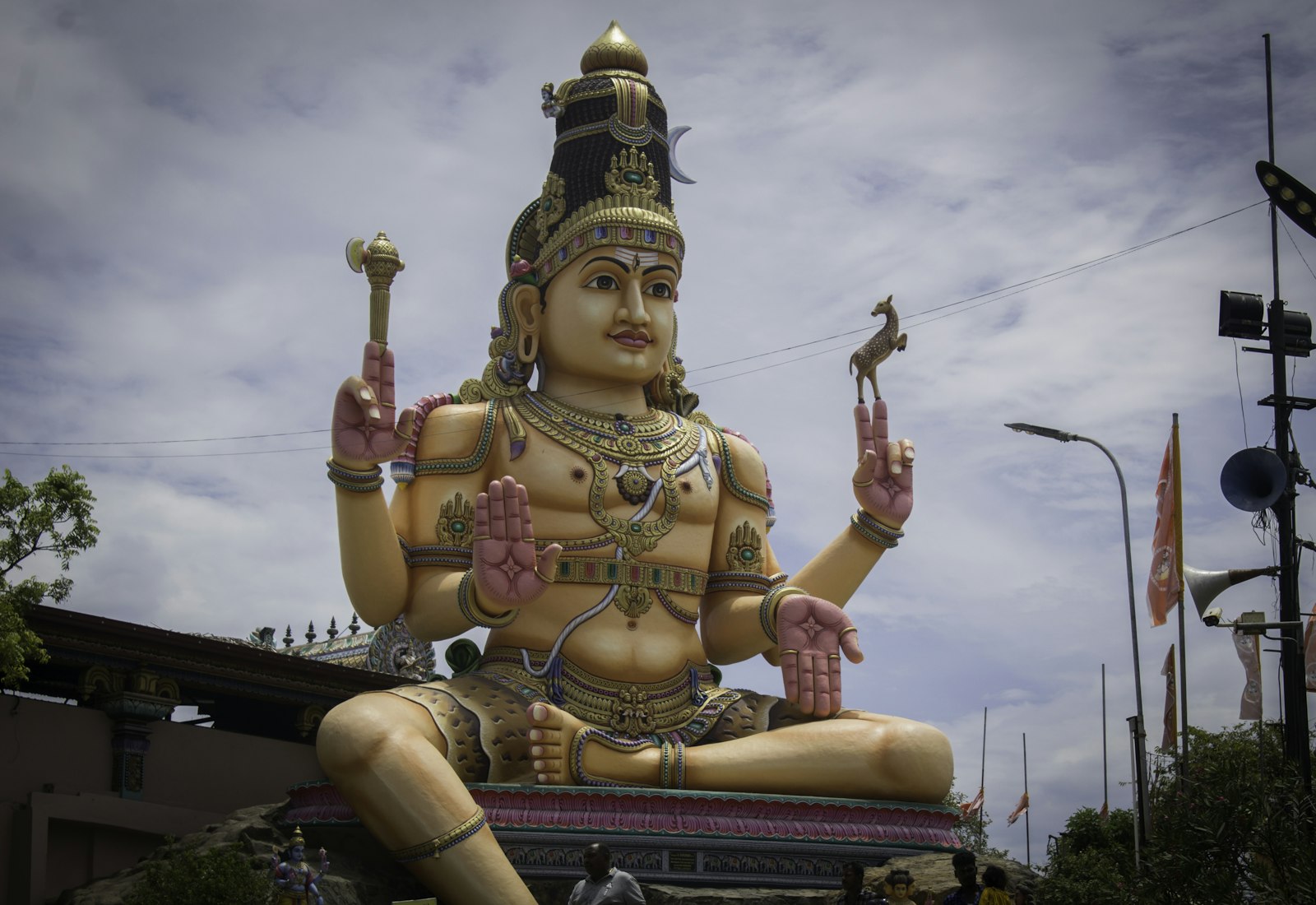 Colourful temple statue on a cliff above the sea