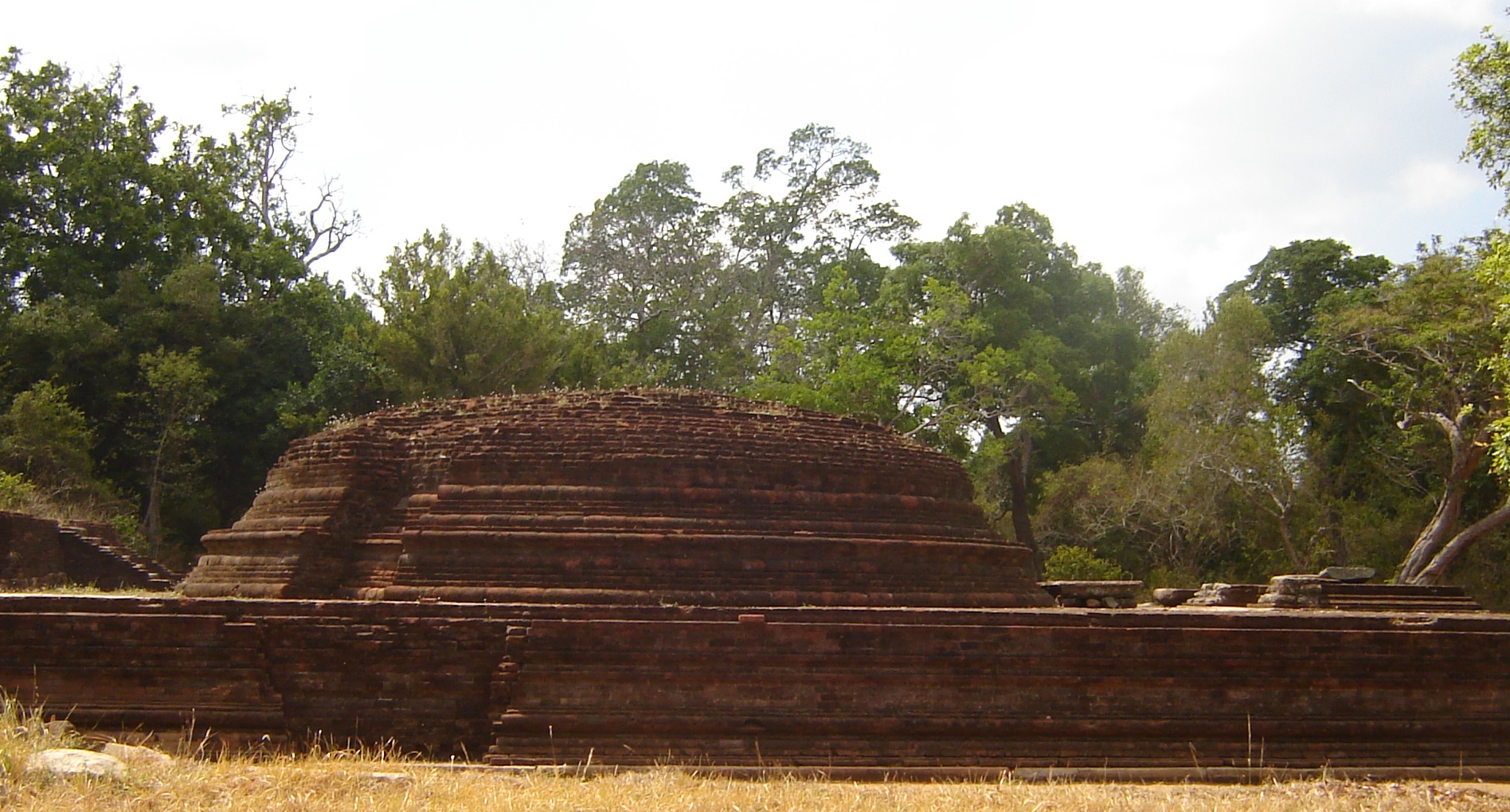 The ancient red-brick stupa at Velgam Vehera among the trees